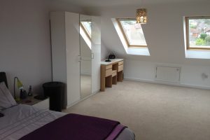 Loft conversion to a semi detached house. Front elevation Velux roof windows. Rear elevation flat roof dormer. Side elevation gable wall construction. 1 bedroom to loft conversion with en-suite shower room. Staircase positioned above existing and oak handrail.