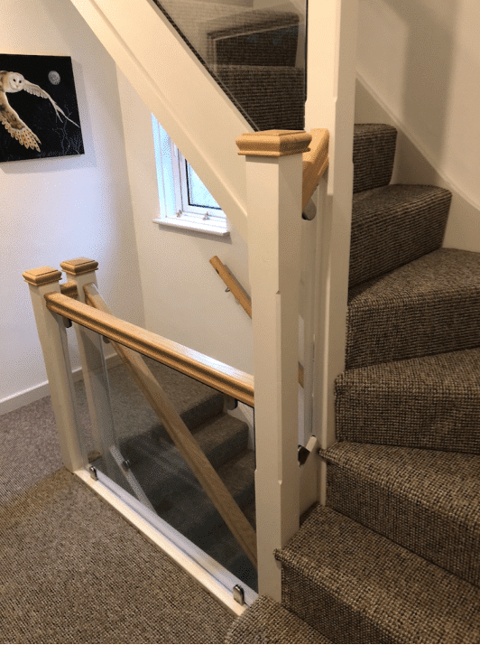 Staircase has oak handrail with 10mm toughened glass panels. Stainless steel brackets.